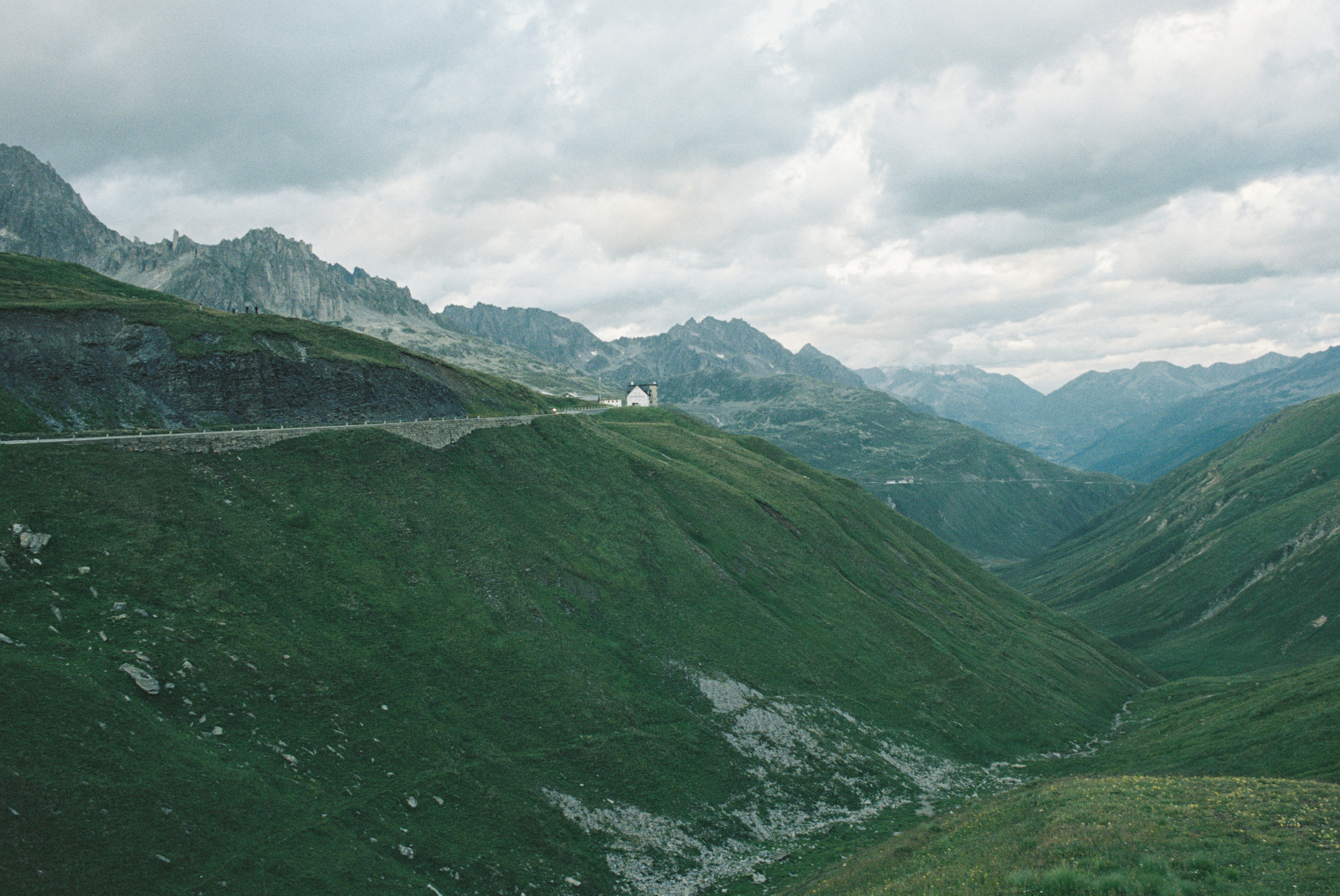 A visualization of a 10-dimensionsal isotropic normal distribution **projected** to 2-D with principal component analysis and color with a terrain color pallette via a 2d kernel density estimator. Higher density regions are white lower densitys move through an earthy grey-brown into a green-grey, suggesting a high-altitude mountain and a subalpine-nival ecotone.